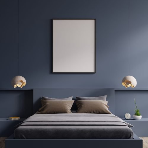 Poster mockup with vertical frame on empty dark blue wall in bedroom interior.3d rendering